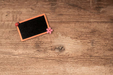 a chalkboard on wooden surface with copy spaceの写真素材
