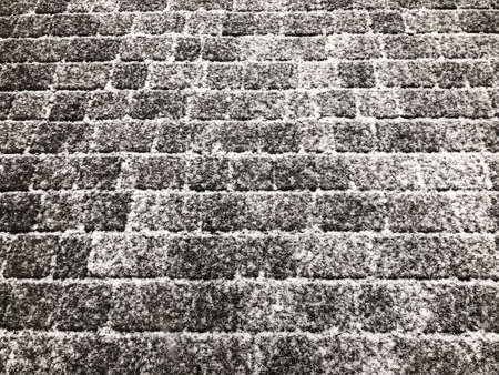 background with a cobblestone street under snow in winterの写真素材