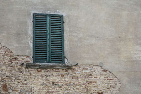 closed green window blind of a building