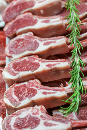 row of raw lamb chop pieces as a backgroundの写真素材