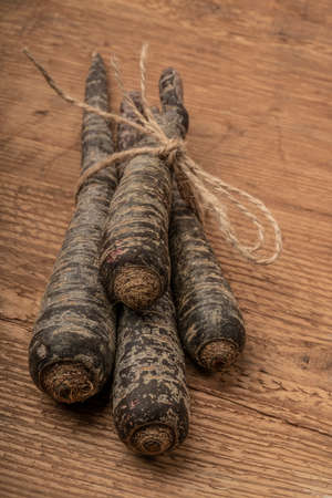 some red carrots on wooden table with copy space