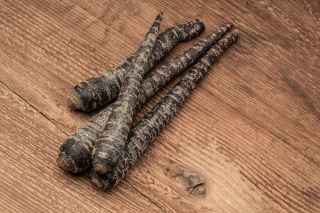 some red carrots on a wooden table with copy spaceの写真素材