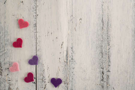small colorful hearts on a wooden background with copy spaceの写真素材