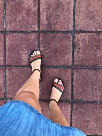 closeup feet of a woman wearing sandals walkingの写真素材