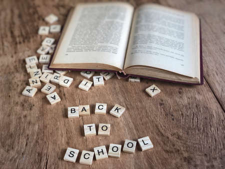 back to school template with cube letters and book on tableの写真素材