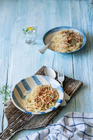 Spaghetti pasta on a wooden table with copy spaceの写真素材