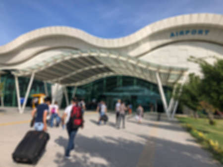 Blurred background with people entering into a airport in the daytimeの写真素材