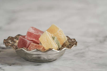 colorful turkish delights in a bowl on a tableの写真素材