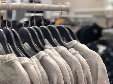 closeup hanged gray t-shirts in a storeの写真素材