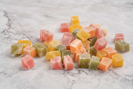 colorful turkish delights on a marble table as a backgroundの写真素材