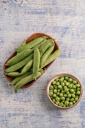 fresh whole peas and seeds on a wooden table with copy spaceの写真素材