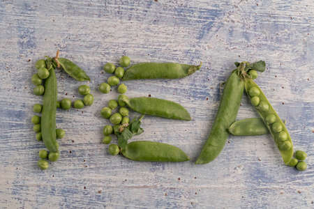 raw peas on a wooden table with copy spaceの写真素材