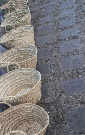 handmade straw bags at street in a rowの写真素材