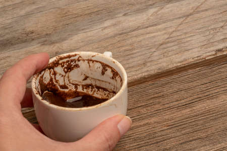 female hand holding a cup of coffee