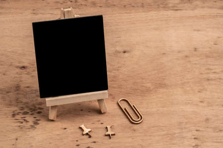 back to school template with an empty chalkboard on a wooden tableの写真素材