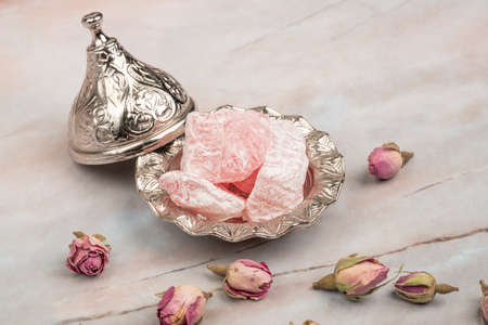 Turkish delights and edible roses on a tableの写真素材