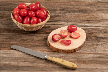 whole and cut into half cranberry fruits on a wooden tableの写真素材