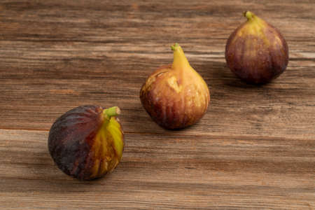 fresh and ripe figs on a wooden table with copy space