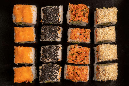 variety of sushi rolls as a background on blackの写真素材