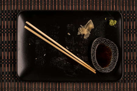 left overs after eating sushi with chopsticks on tableの写真素材