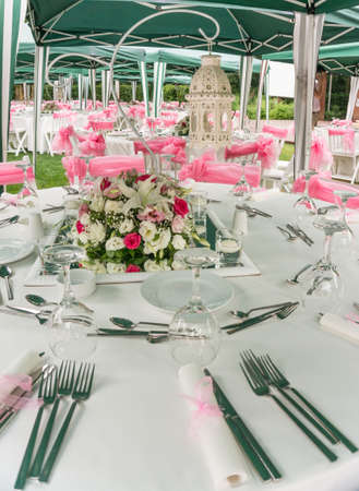 tables set with flowers and ribbons for a outdoor wedding