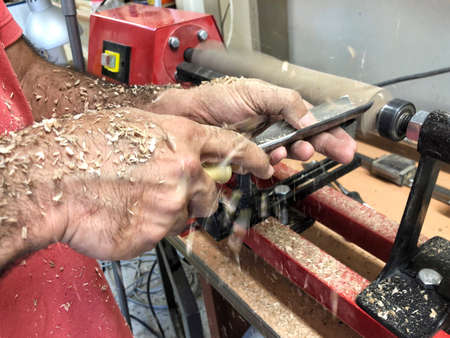 closeup hands of a carpenter working with revolverの写真素材