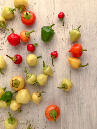 variety of colorful fresh peppers on a wooden table