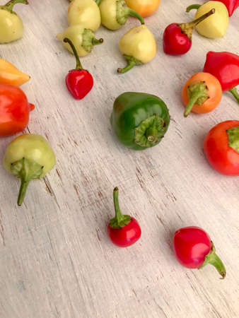 variety of colorful fresh peppers on a wooden table