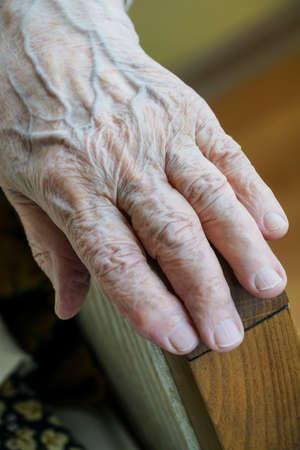 closeup wrinkled hands of an old person with copy space