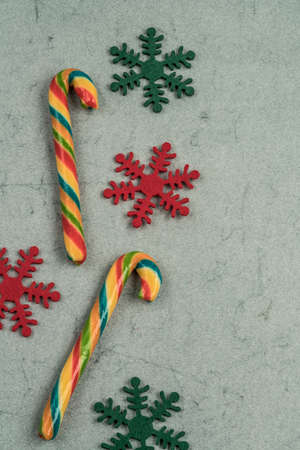 stick candy canes on a green background for new yearの写真素材