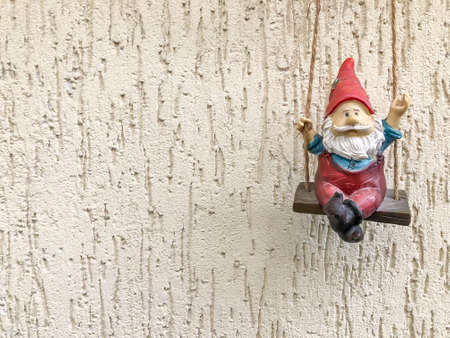 A small santa clause figurine hanged on wall with copy space for new year