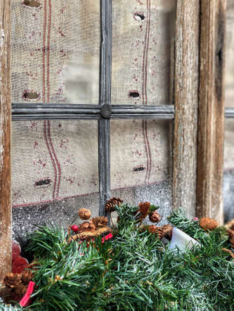 noel decoration with pine tree branches in front of a window, outdoor