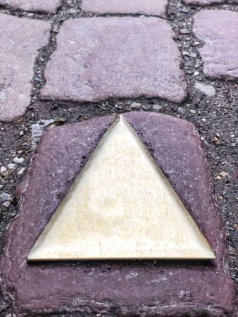 A direction sign on cobblestone road with copy spaceの写真素材