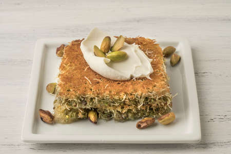 traditional Turkish dessert kadayif with pistachio on tableの写真素材