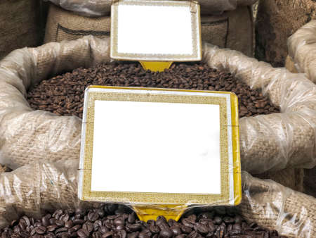 roasted coffee beans in burlap sacks with blank name labels