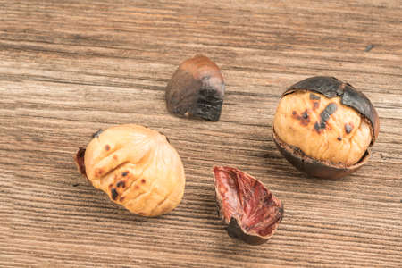 closeup roasted chestnuts on a wooden table