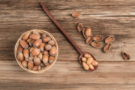 closeup fresh hazelnuts on a wooden table with copy spaceの写真素材