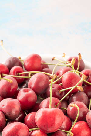 closeup fresh ripe wet cherry fruits on plate