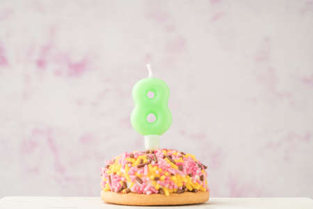a small colorful cupcake with number eight shaped candle for birthday celebrationの写真素材
