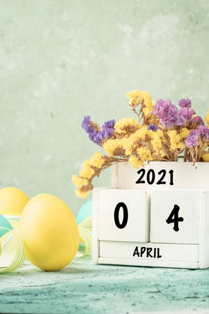 easter template with colorful eggs and cube calendar over green with copy space