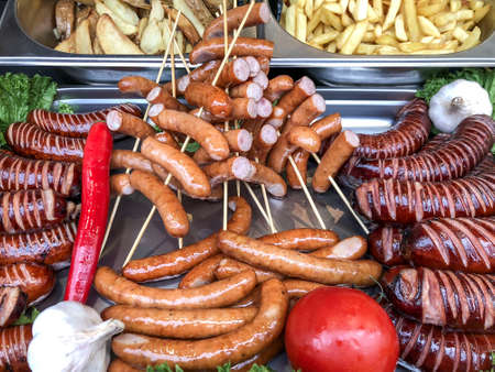 closeup variety of grilled hotdogs and meatsの写真素材