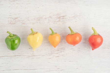 colorful fresh peppers on a wooden table with copy space