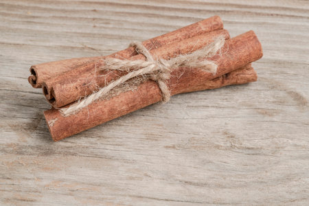 some dried cinnamon sticks on the wooden table with copy space