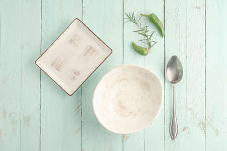 empty and clean bowl and plate on a green wooden table with copy space