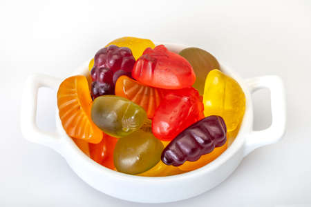 close up colorful jelly candies on a white plateの写真素材