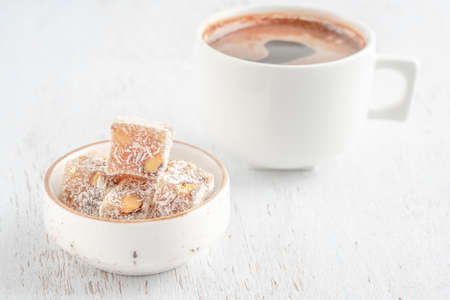 Turkish delights and cup of coffee on wooden table with copy spaceの写真素材