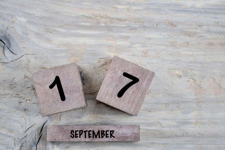 closeup cube calendar for september on a wooden background with copy spaceの写真素材