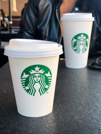 Istanbul, Turkey - October 21, 2021; Starbucks coffee take away cups on the table in the shop in Istanbul, Turkey. selective focusのeditorial素材