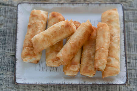 closeup fried spring rolls made by phyllo dough on the table. traditional Turkish and Balkan food