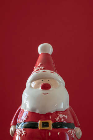 new year, Christmas greeting card with Santa Claus figurine isolated on red with copy space. Christmas or christmas ornaments on red. vertical new year cardの写真素材